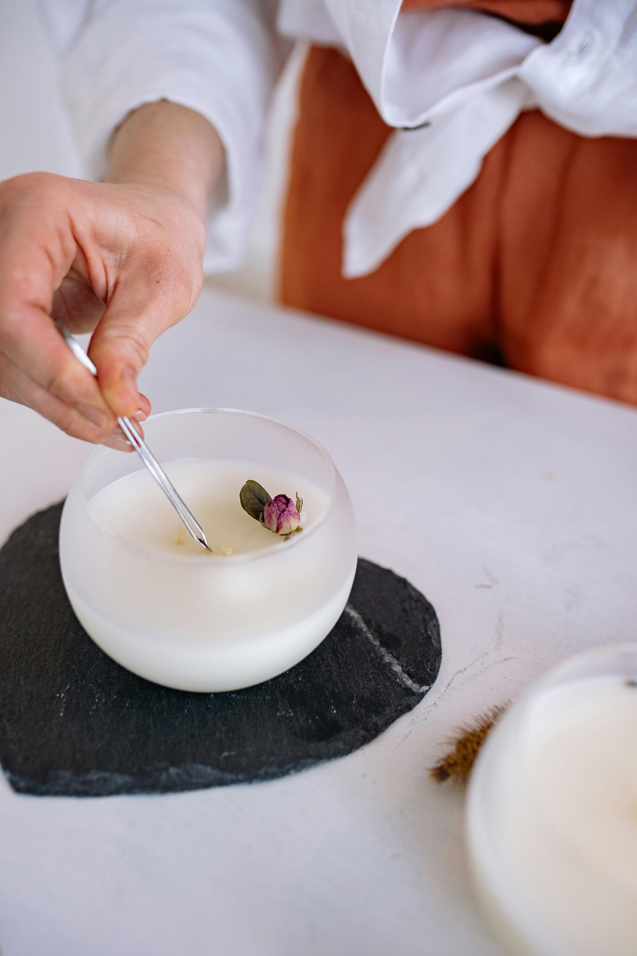 Adding dried botanicals to finished candles
