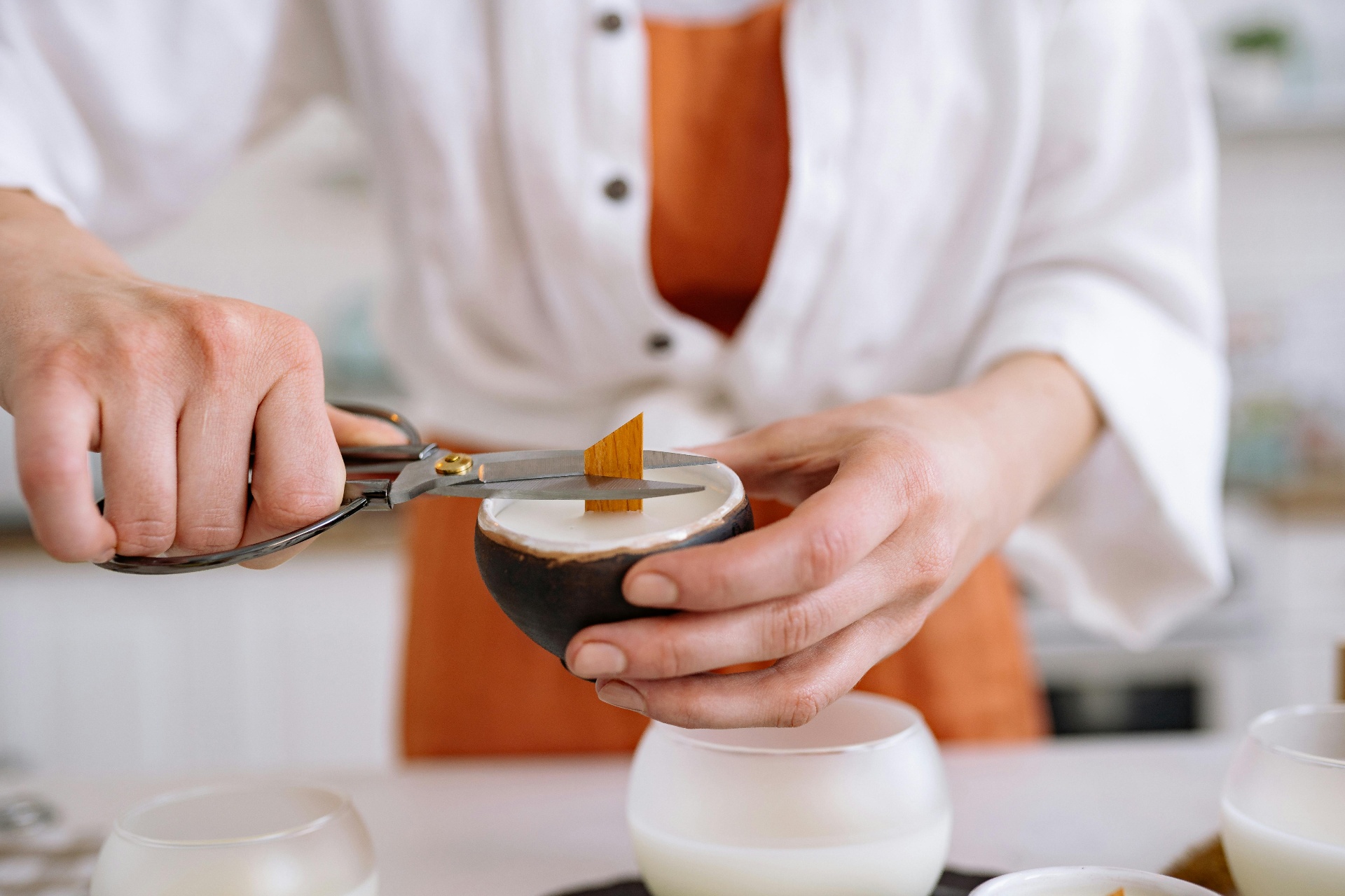 Artisan trimming a candle wick