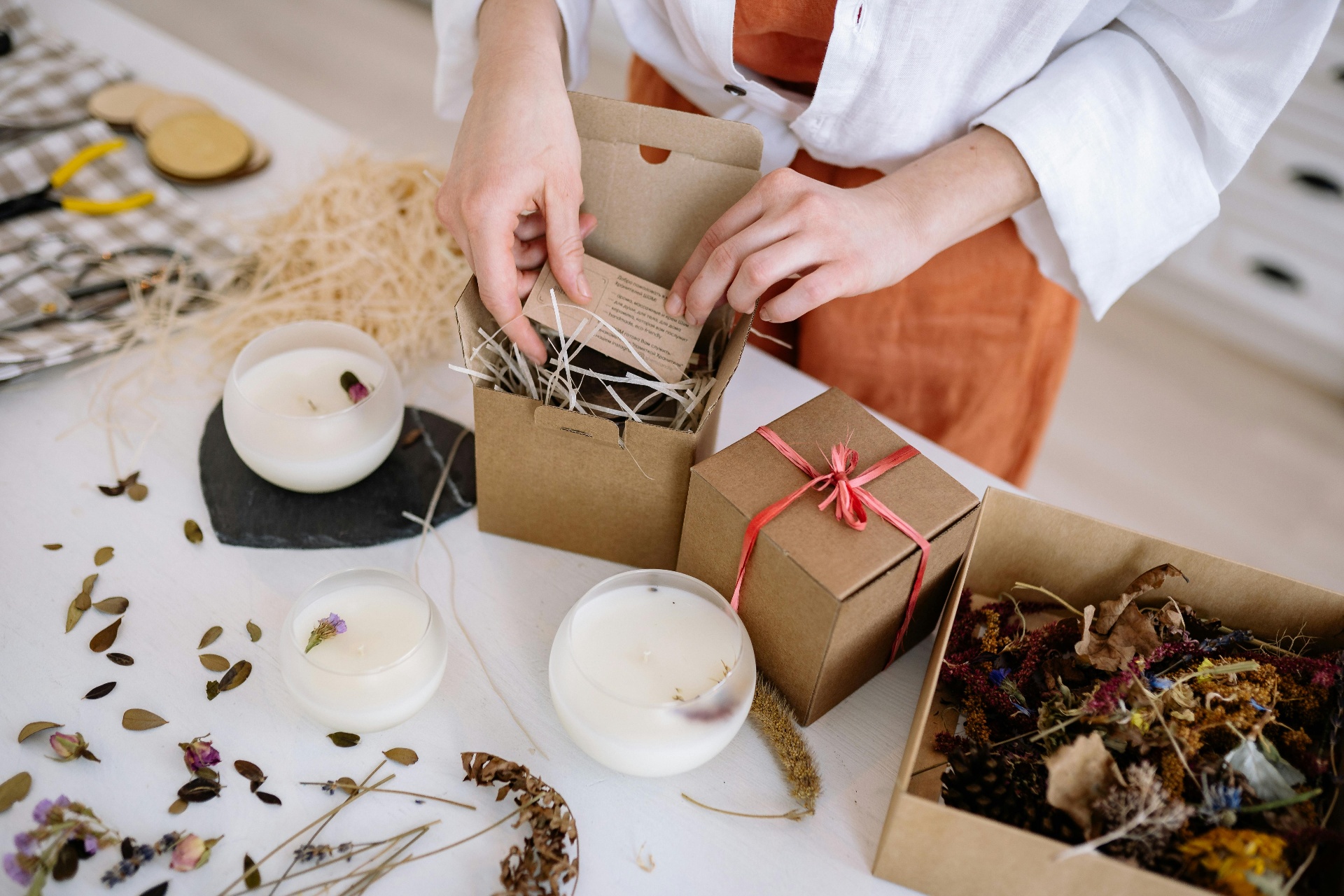 Person packaging candles in an eco-friendly gift box